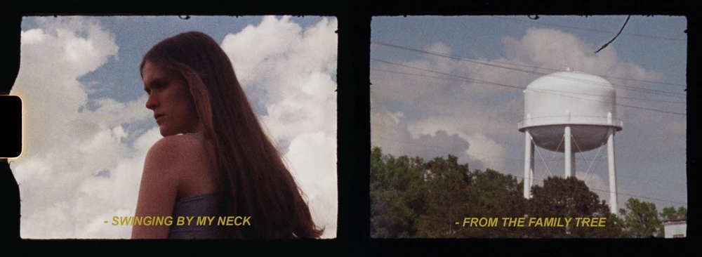 Preacher's Daughter era, Family Tree film still, bare shoulders against the clouds, and the town water tower